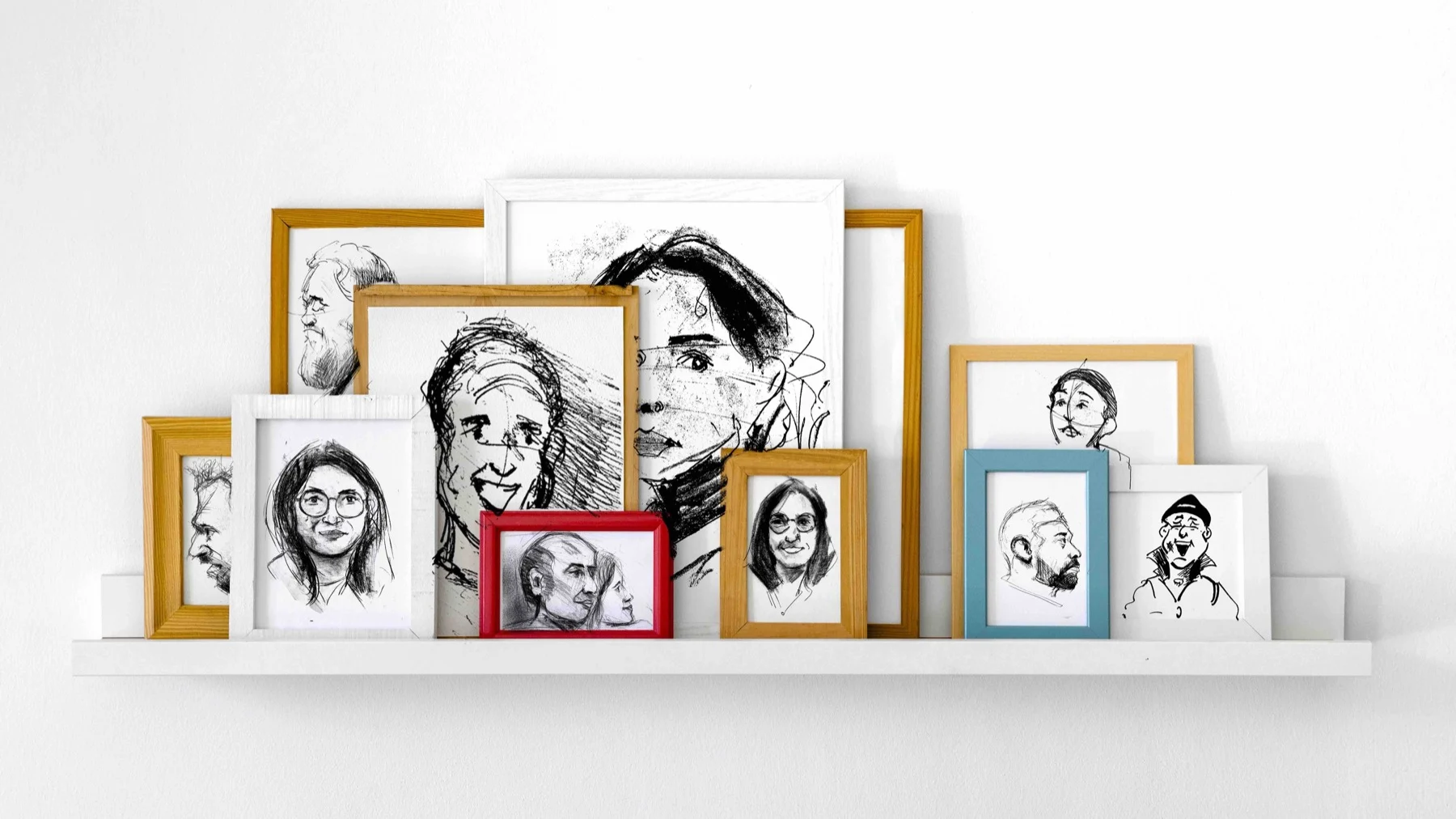 A display of drawn portraits in colourful frames